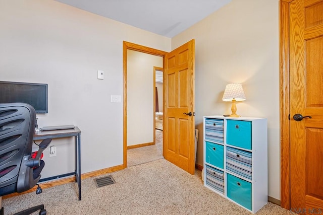 office space with baseboards, visible vents, and carpet flooring