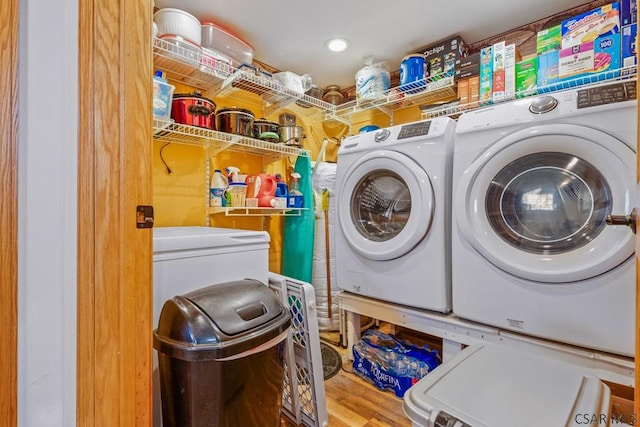 laundry room featuring laundry area, washer and clothes dryer, and wood finished floors