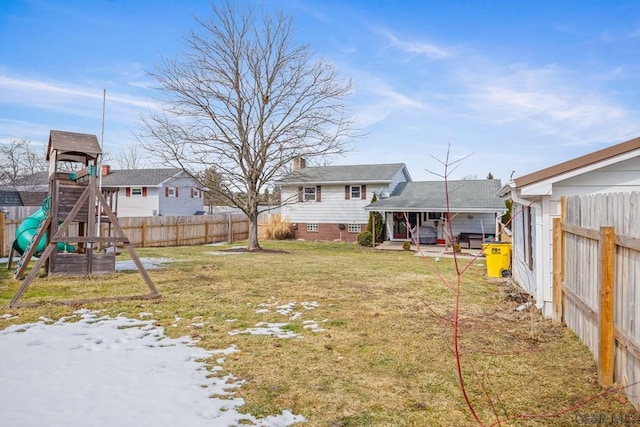 view of yard with fence and a playground