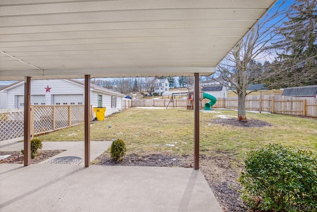 view of patio with a playground and a fenced backyard