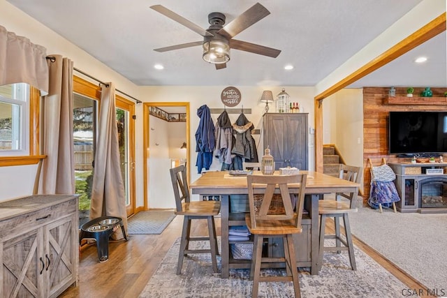 dining area with a healthy amount of sunlight, light wood finished floors, stairway, and recessed lighting