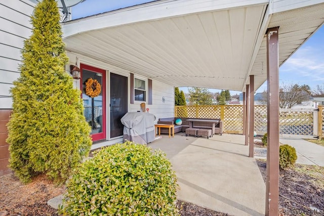 view of patio with a grill and fence