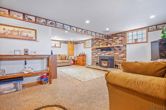 living room with carpet floors, recessed lighting, a wood stove, and a healthy amount of sunlight