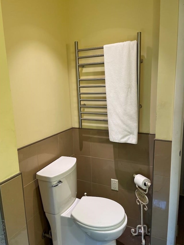 230 Trading Post Rd, Stoystown, PA 15563 - half bathroom featuring tile walls, toilet, radiator, a towel warming rack, and wainscoting