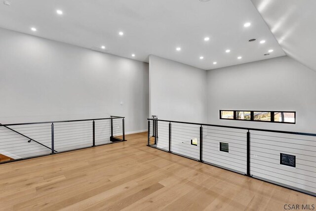 interior space featuring lofted ceiling and light hardwood / wood-style floors