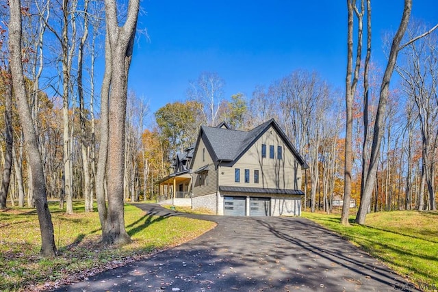 view of property exterior with a garage and a lawn