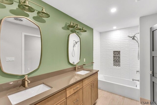 bathroom featuring vanity and tiled shower / bath combo