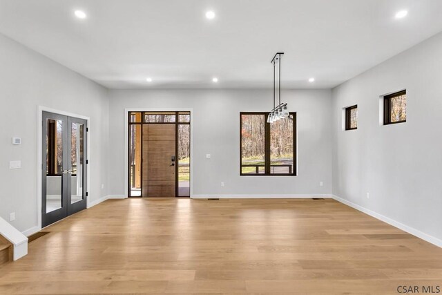 interior space with french doors and light hardwood / wood-style floors