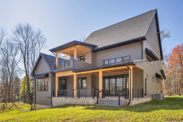 view of front of house featuring a balcony and a front yard