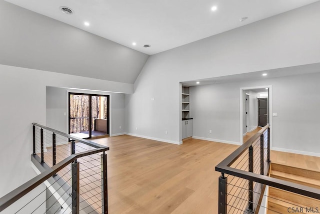 living room featuring vaulted ceiling and wood-type flooring