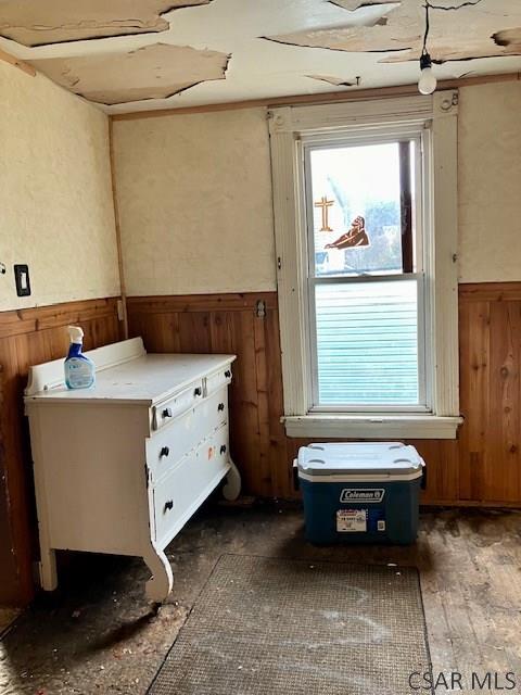 miscellaneous room featuring wood walls