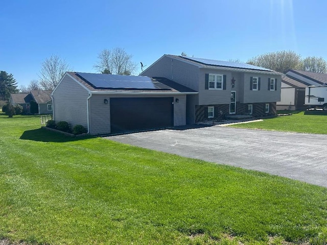 1501 Maplehurst Dr, Somerset, PA 15501 - view of front of house featuring solar panels, driveway, an attached garage, and a front yard