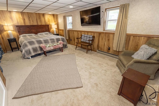 1501 Maplehurst Dr, Somerset, PA 15501 - bedroom featuring a baseboard radiator, wood walls, carpet, wainscoting, and a drop ceiling