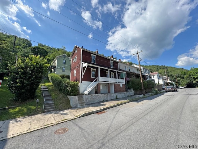 603 Woodvale Ave, Johnstown, PA 15901 - view of front of home featuring stairway, a porch, a residential view, and a chimney