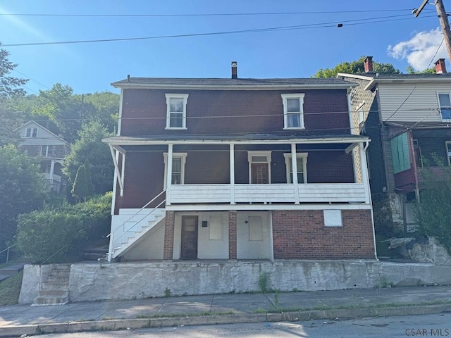 603 Woodvale Ave, Johnstown, PA 15901 - view of front of property with stairs, brick siding, and covered porch