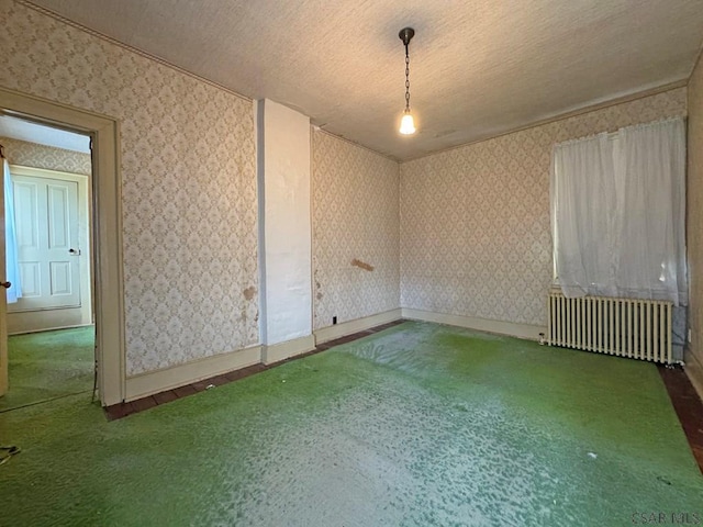 603 Woodvale Ave, Johnstown, PA 15901 - carpeted empty room featuring radiator heating unit, wallpapered walls, and a textured ceiling