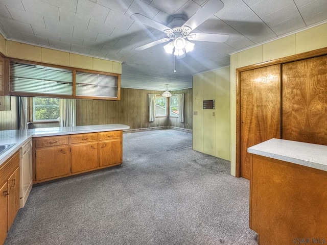 751 Pike Rd, Johnstown, PA 15909 - kitchen featuring carpet, ceiling fan, light countertops, brown cabinets, and wood walls