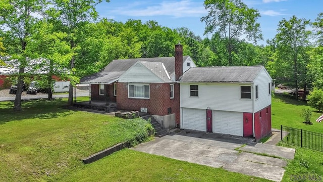 751 Pike Rd, Johnstown, PA 15909 - rear view of house with concrete driveway, an attached garage, and a chimney