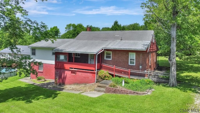 751 Pike Rd, Johnstown, PA 15909 - back of property featuring a chimney, brick siding, and a yard