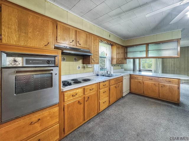 751 Pike Rd, Johnstown, PA 15909 - kitchen featuring stainless steel appliances, under cabinet range hood, light countertops, a peninsula, and brown cabinets