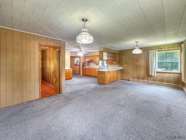 751 Pike Rd, Johnstown, PA 15909 - kitchen featuring a baseboard radiator, a peninsula, brown cabinets, open floor plan, and light colored carpet