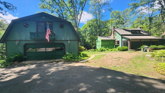 view of side of home featuring a yard and an outdoor structure