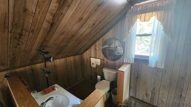 bathroom with lofted ceiling, wooden ceiling, and wooden walls