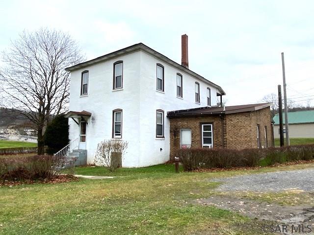 view of property exterior featuring a lawn