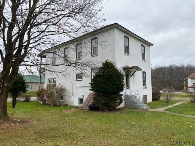 view of home's exterior with a lawn