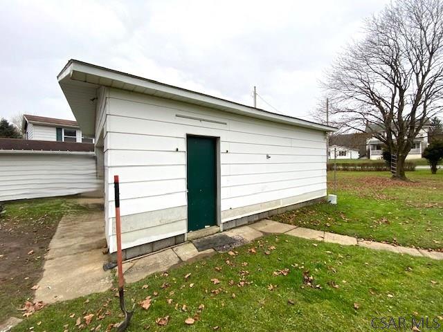 view of outdoor structure with a lawn