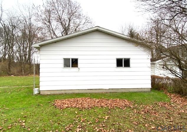 view of property exterior with a lawn