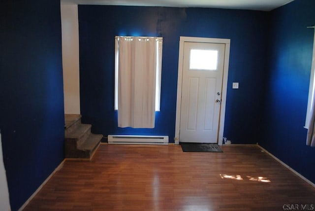 foyer entrance featuring hardwood / wood-style flooring and a baseboard radiator