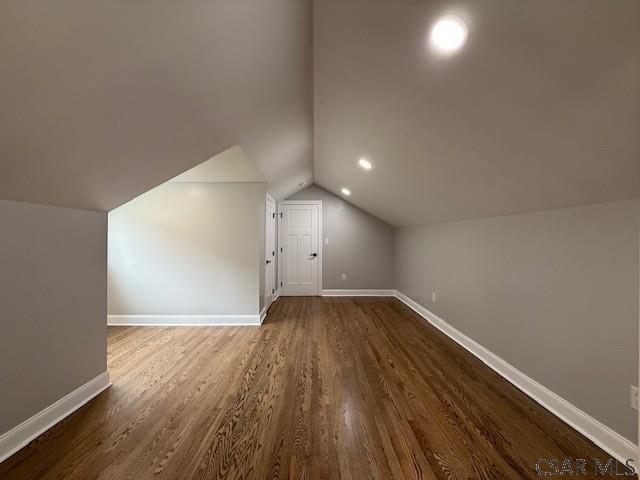 2200 Dundee Ln, Johnstown, PA 15905 - additional living space with dark wood-style floors, baseboards, and lofted ceiling