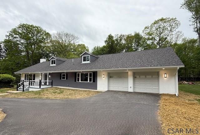 2200 Dundee Ln, Johnstown, PA 15905 - single story home with an attached garage, asphalt driveway, a porch, and stucco siding