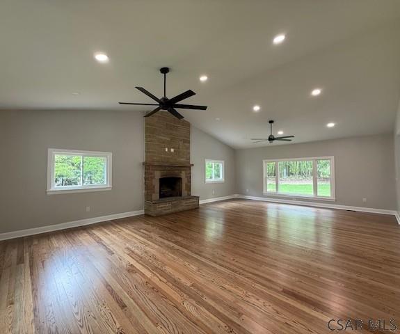 2200 Dundee Ln, Johnstown, PA 15905 - unfurnished living room featuring ceiling fan, baseboards, wood finished floors, vaulted ceiling, and a fireplace