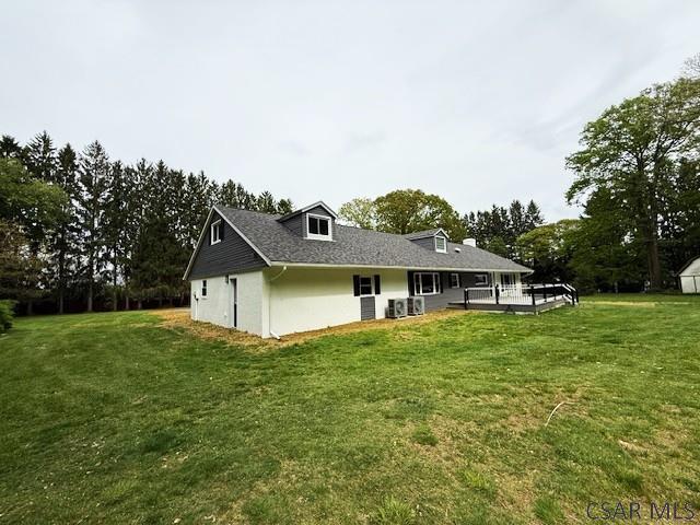 2200 Dundee Ln, Johnstown, PA 15905 - back of house featuring a yard, stucco siding, and view of wooded area