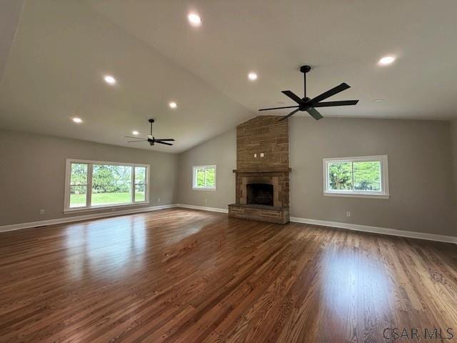 2200 Dundee Ln, Johnstown, PA 15905 - unfurnished living room featuring a ceiling fan, wood finished floors, a fireplace, baseboards, and vaulted ceiling