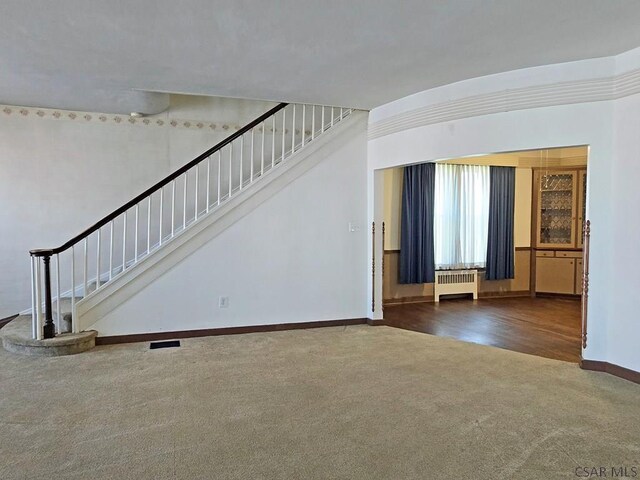 17 Grant St, Salisbury, PA 15558 - unfurnished living room with carpet, radiator heating unit, baseboards, and stairway