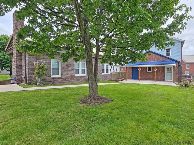 17 Grant St, Salisbury, PA 15558 - view of front of home with stone siding, a chimney, and a patio area