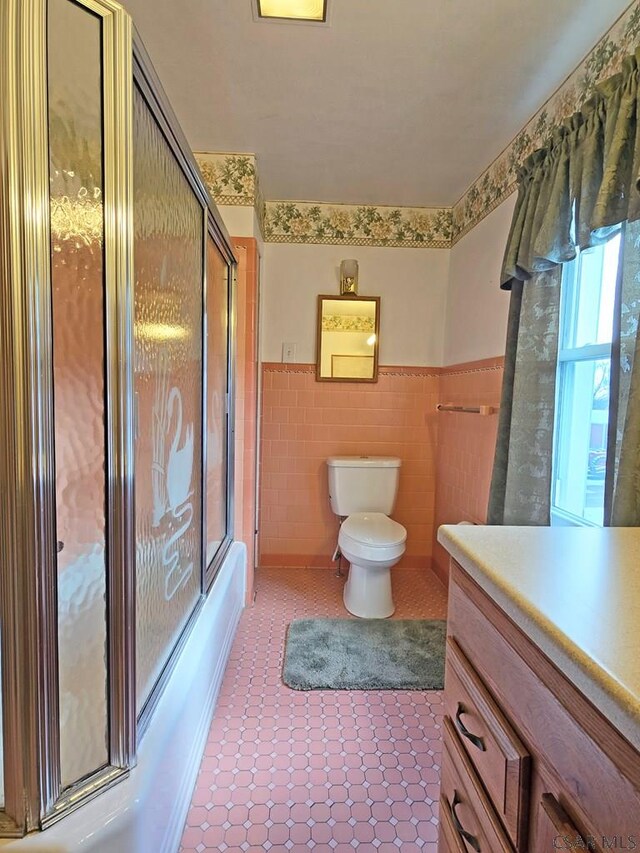 17 Grant St, Salisbury, PA 15558 - full bathroom with vanity, tile walls, tile patterned floors, toilet, and a wainscoted wall