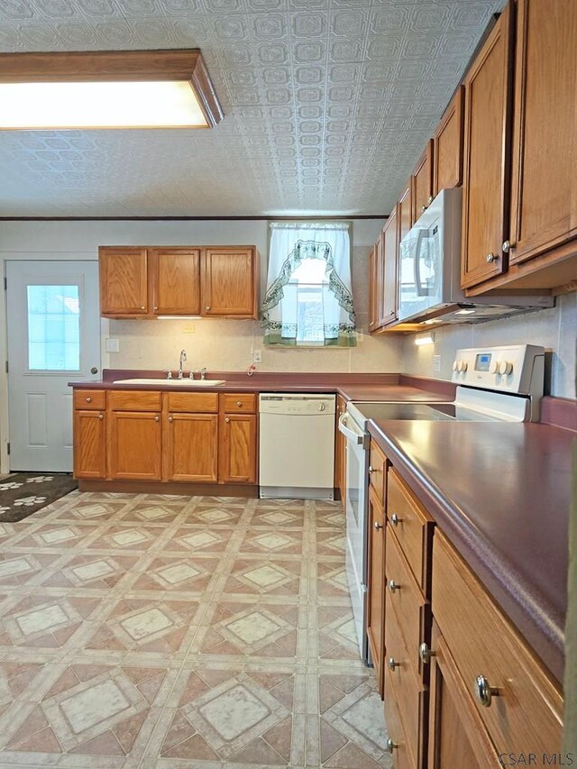17 Grant St, Salisbury, PA 15558 - kitchen with white appliances, brown cabinets, a sink, and an ornate ceiling
