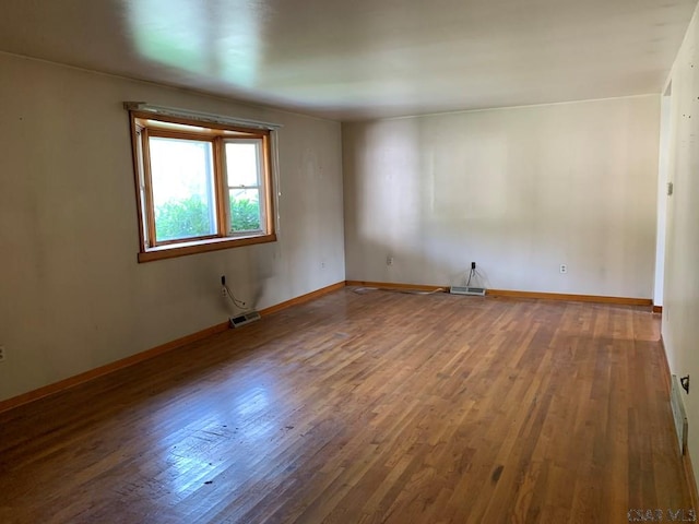 spare room featuring hardwood / wood-style flooring