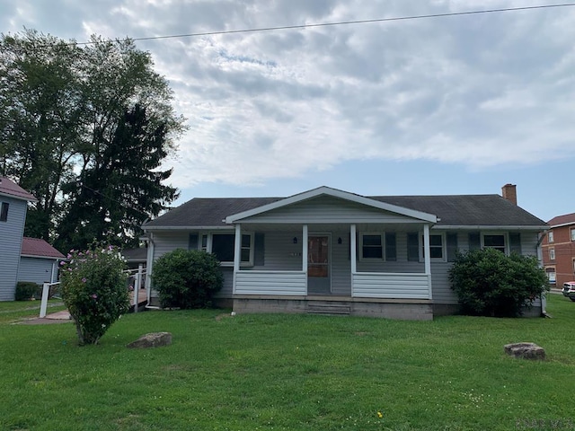 view of front of home featuring covered porch and a front yard