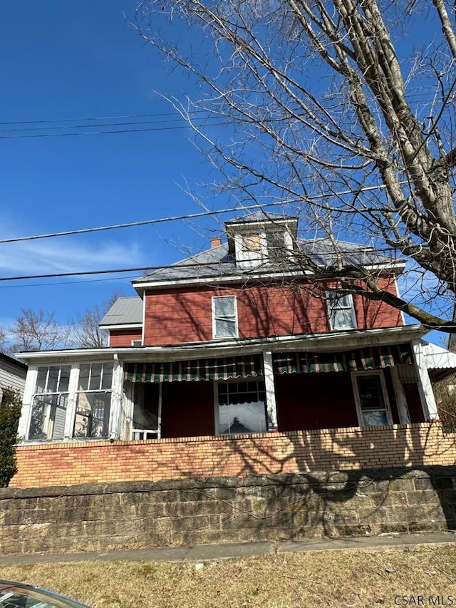 view of front of house featuring a sunroom