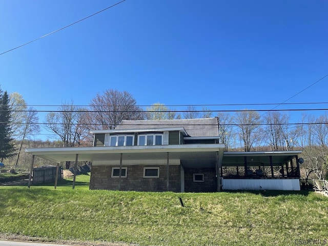 back of house with a lawn