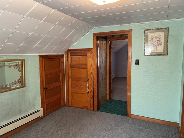 additional living space with vaulted ceiling, carpet flooring, and a baseboard heating unit
