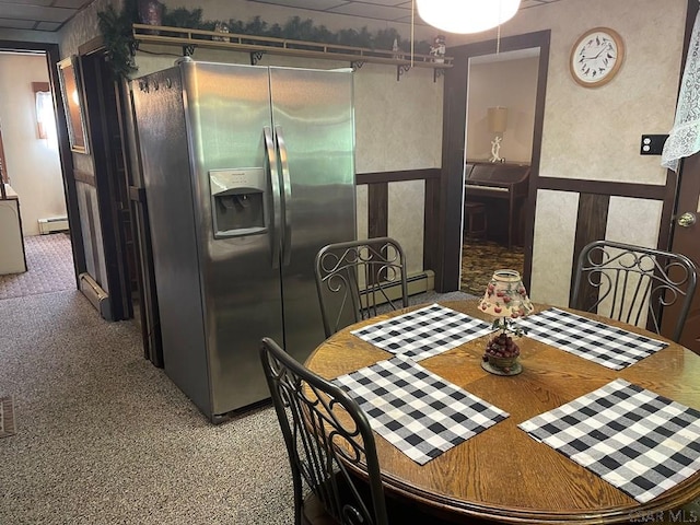 dining area featuring carpet flooring and a baseboard heating unit