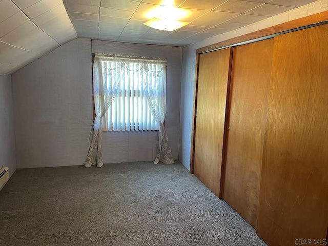 unfurnished bedroom with carpet floors, a closet, and lofted ceiling