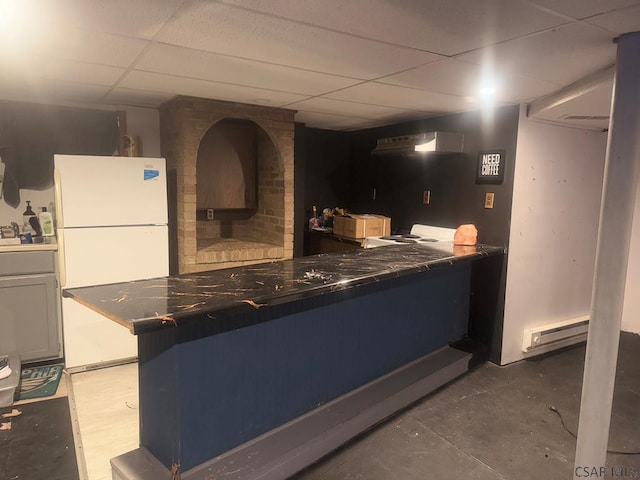 kitchen featuring a baseboard heating unit, a paneled ceiling, and white refrigerator