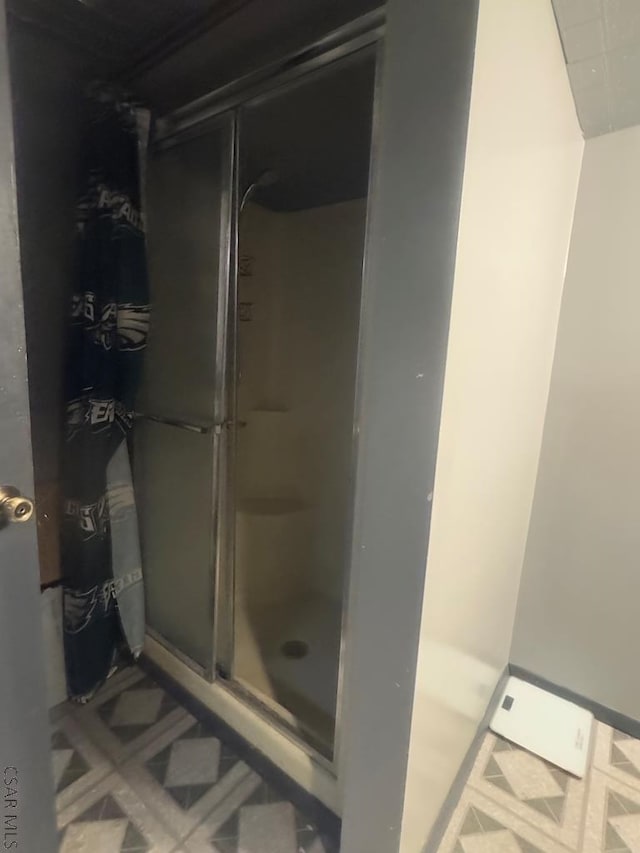 bathroom with a shower with door